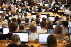 En gruppe studerende kan ses til forelæsning med computerne fremme