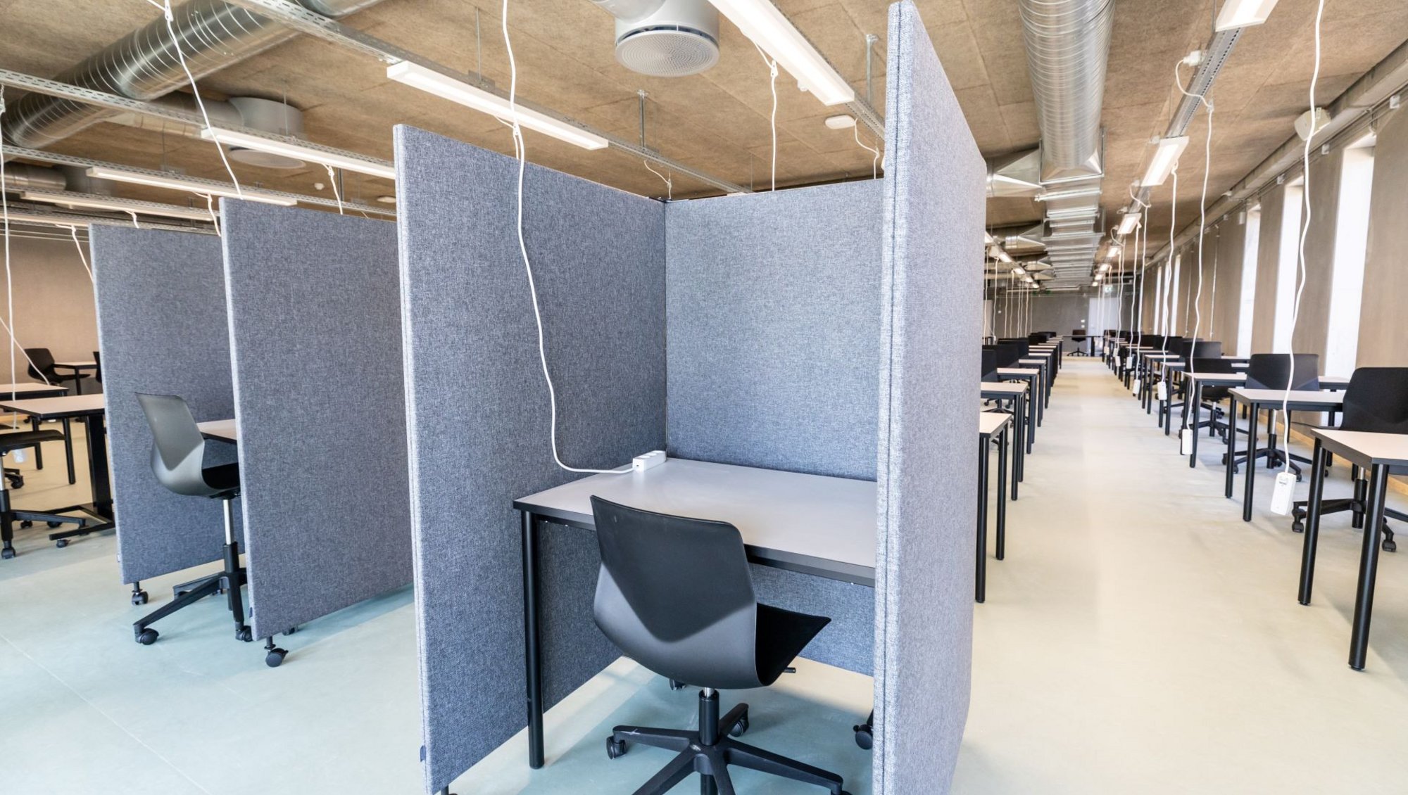 A partitioned desk in communal exam areas