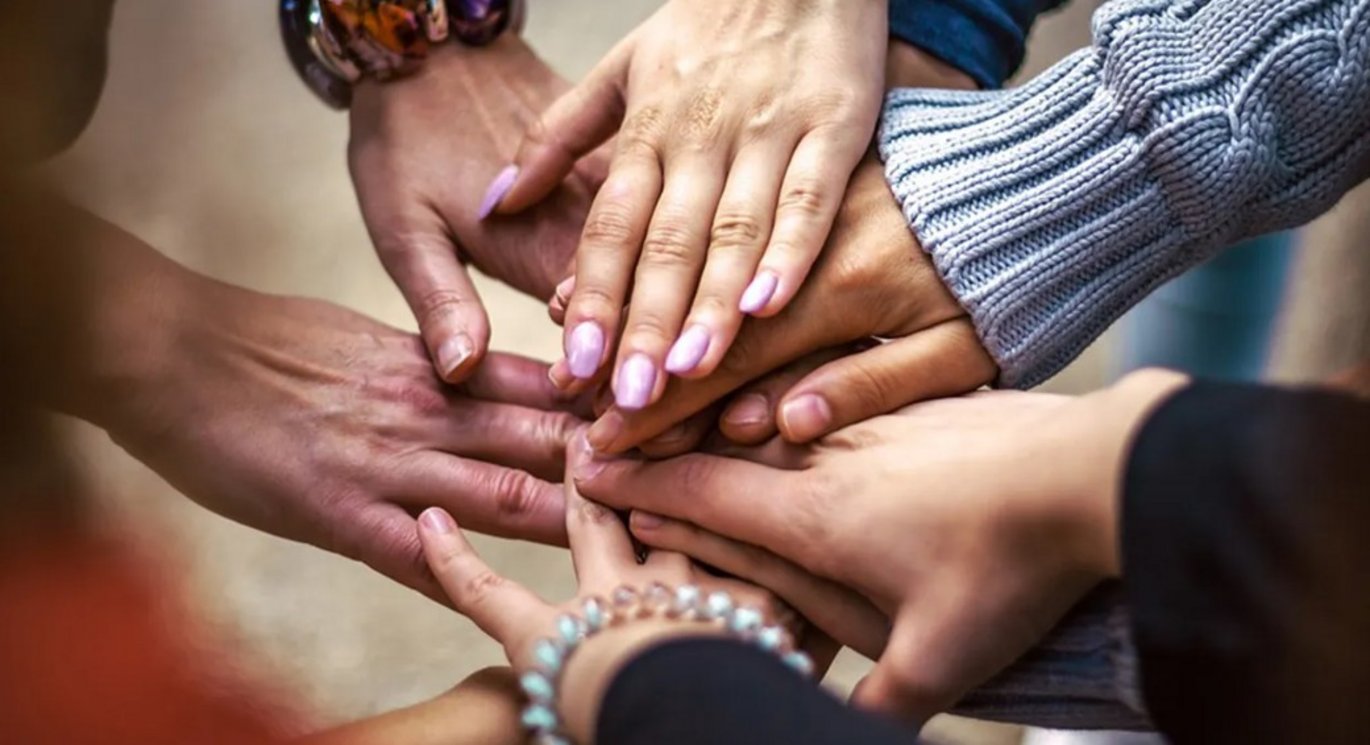 Multiple people holding hands